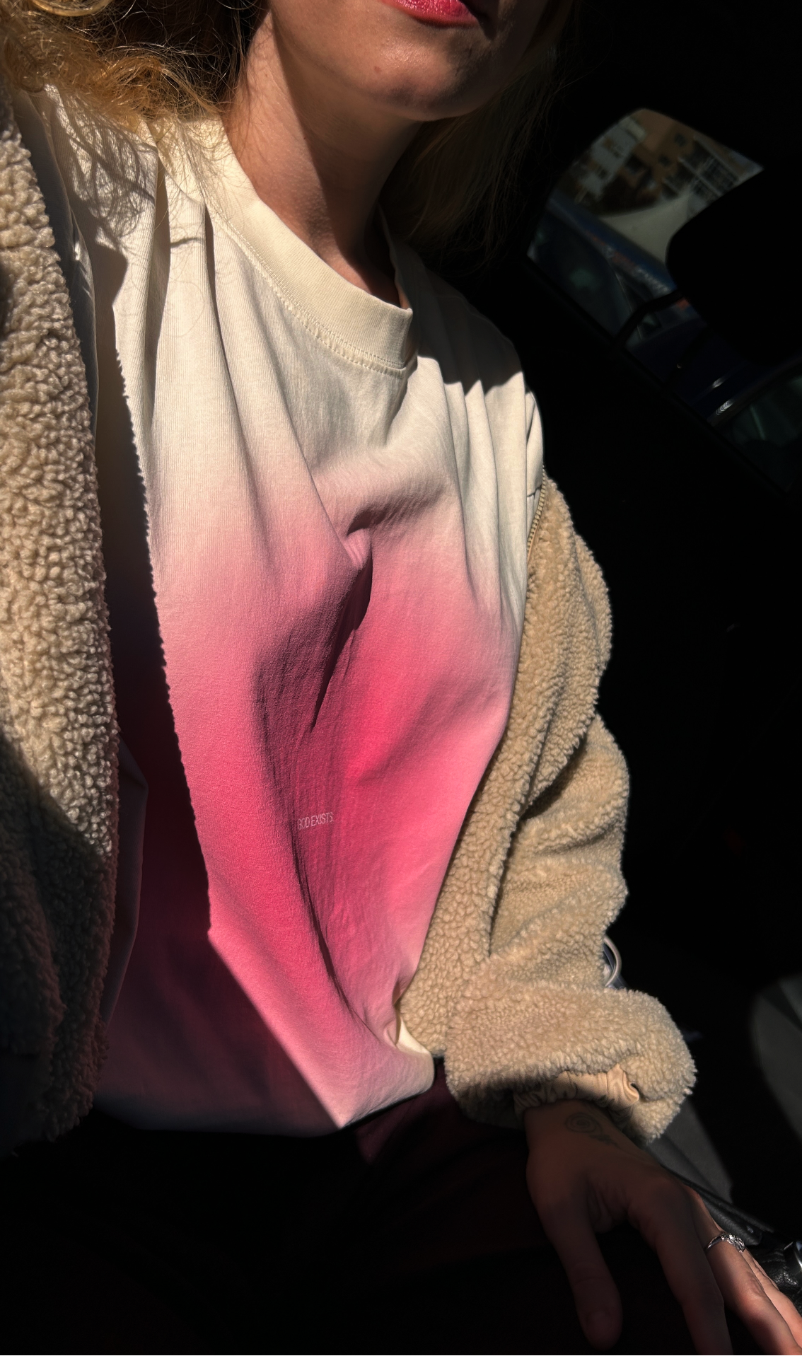 Person wearing a christian t-shirt with pink and white colors